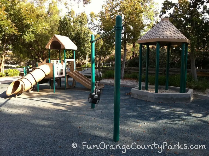 sandbox and swings with tunnel slide playground