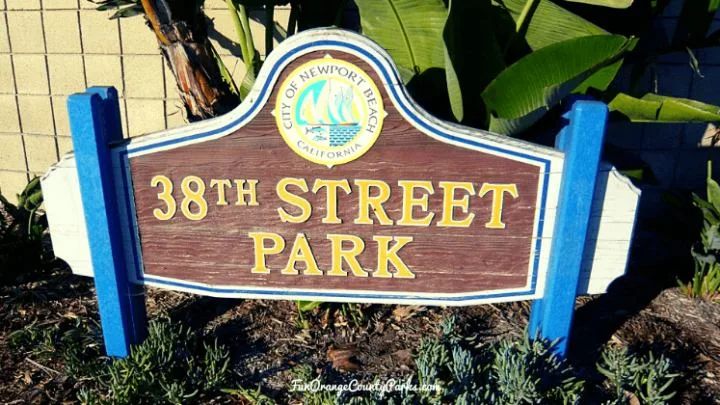 wooden sign with city of newport beach seal and 38th street park written in yellow text