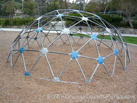 old-fashioned jungle gym dome on a bark play surface