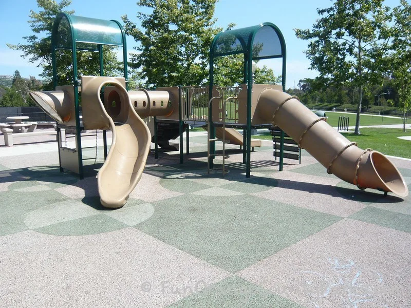 tunnel slide and slightly curved slide on recycled rubber surface