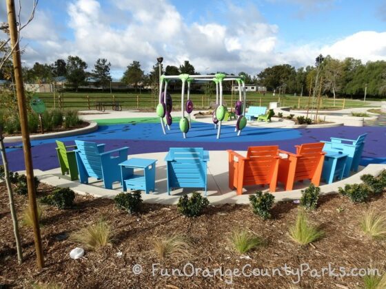 pavion park dance play area with colorful chairs surrounding circular dance floor area with equipment that plays songs