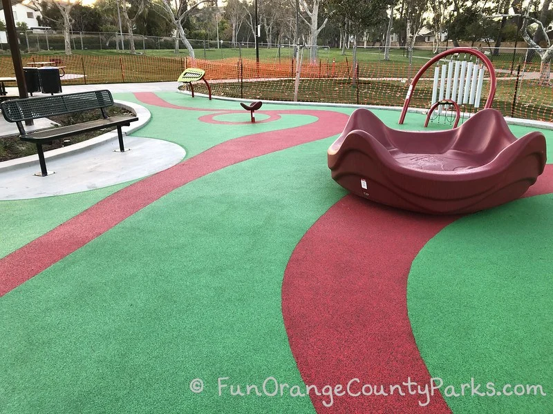 merry-go-round and music panels on green and red recycled rubber surface