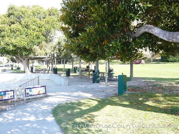 Baby Beach park setting with picnic shelters, trees, and green drinking fountain