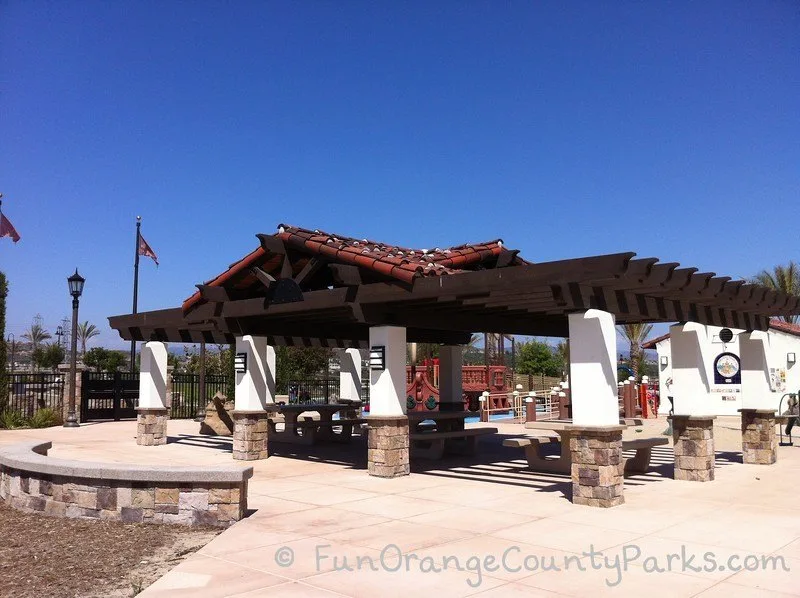 large picnic shelter with red tiled roof and wooden beams 