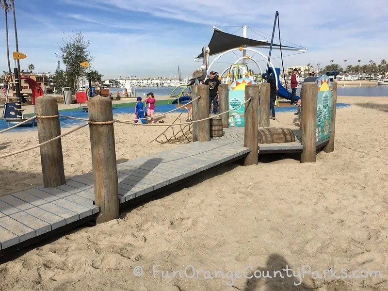 Marina Park playground with pier and play equipment on beach