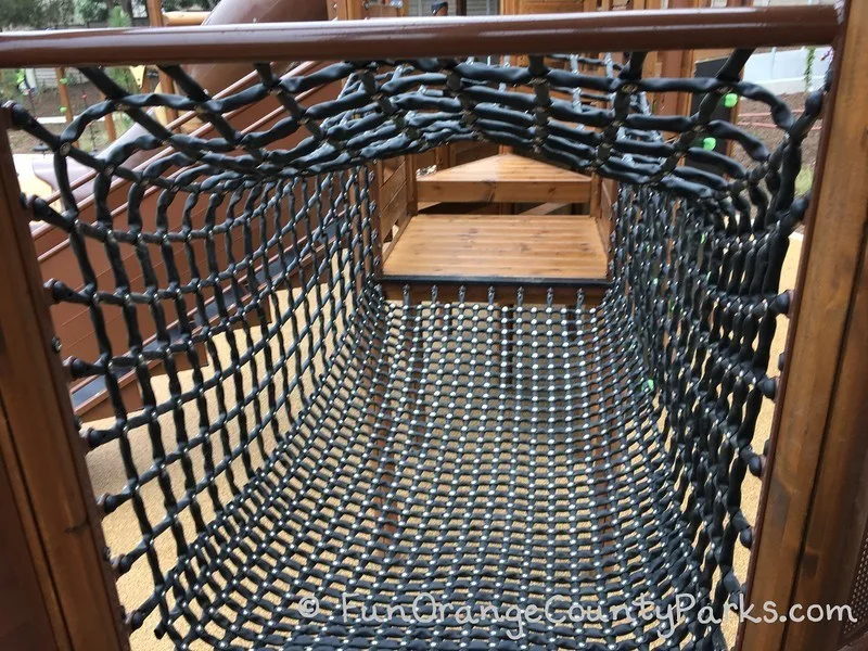 bridge tunnel made of black rope for crawling from one side of structure to the other