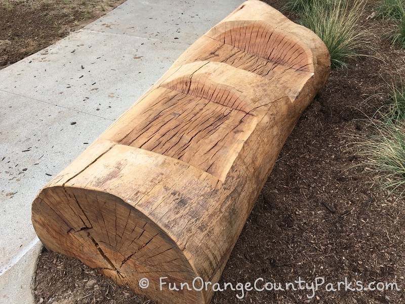 log bench with seating area cut out of the wood