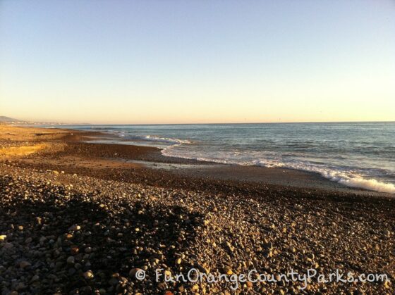 parks and beaches parking passes - capistrano beach rocks and ocean waves along the shoreline at sunset