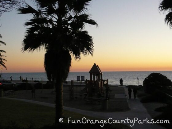 parks and beaches parking passes - aliso beach park at sunset with playground in silhouette