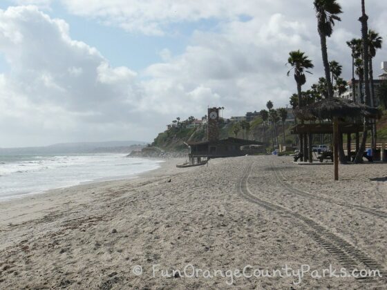 parks and beaches parking passes - san clemente beach near pier with lifeguard station along the sand