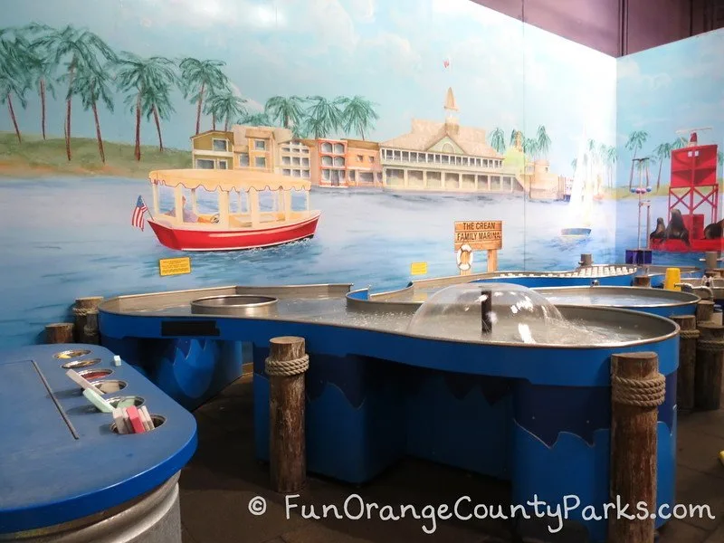 Pretend City marina play area with fountains and floating foam boats