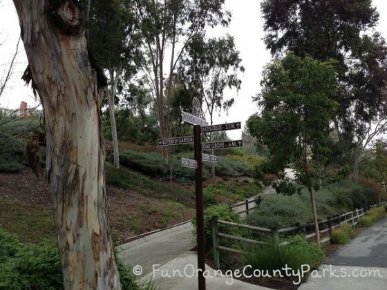sign posts along the oso creek trail with an obvious paved path leading uphill
