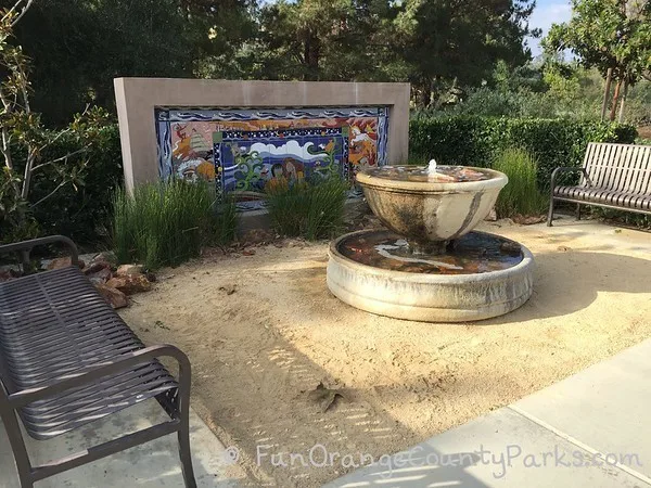mosaic art of the area next to a fountain to form an outdoor sitting area at oso viejo park