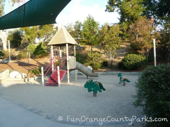 Dino Park in Laguna Hills view of dinosaur spring toys and small childrens playground