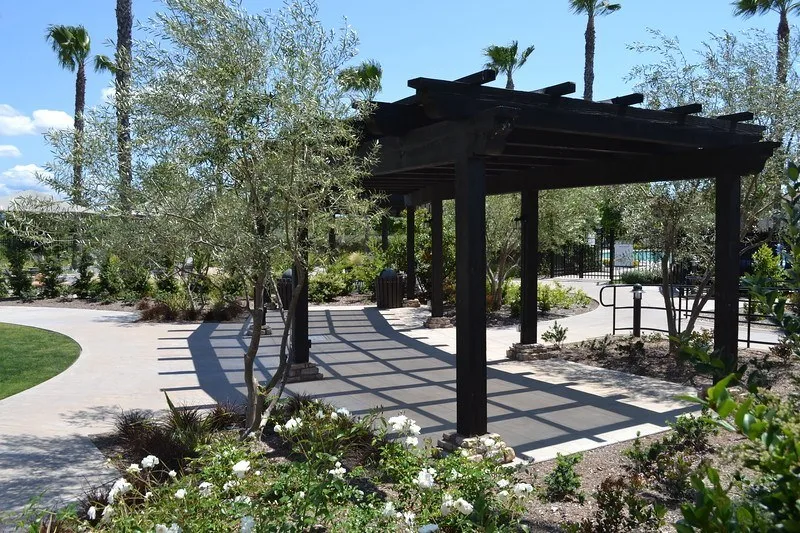 shaded area covered by a dark wood shade cover over concrete