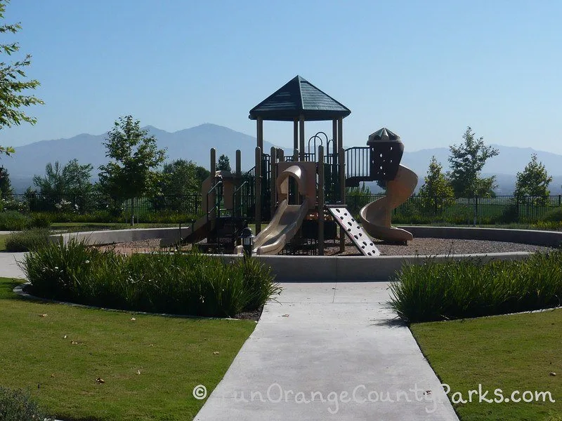 small playground encircled by short 1-foot concrete wall