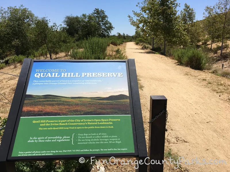 Quail Hill Preserve trail sign on left with dirt trail heading off in the distance on the right