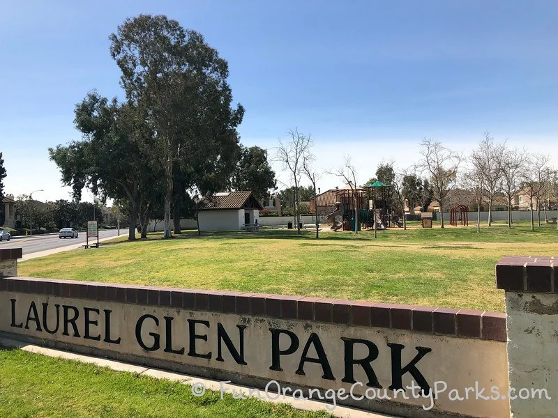 park sign with playground in the background