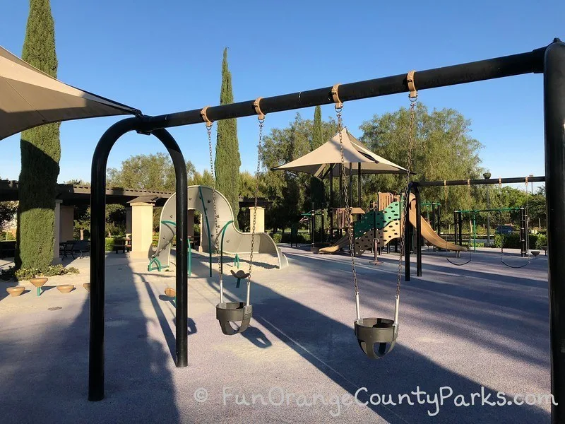 Stonegate Park in Irvine park overview photo with baby swings in the foreground
