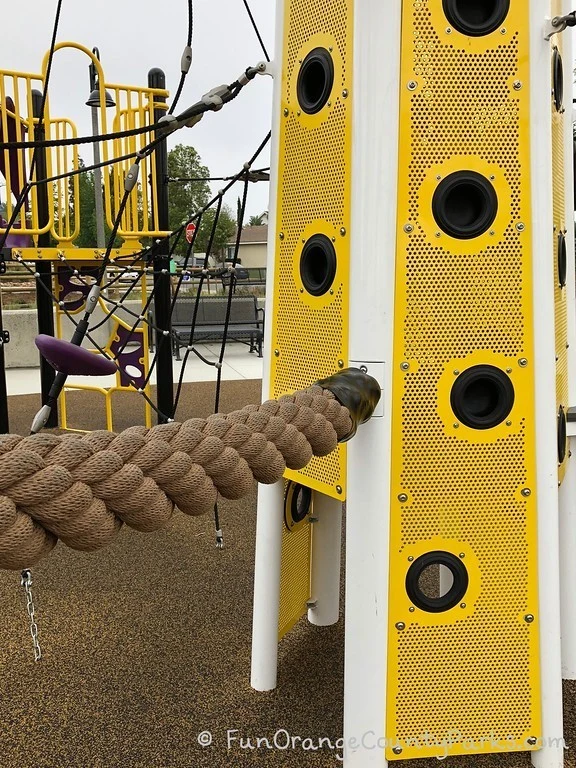 close up of climbing elements like think rope swing, footholds, and rope climbers