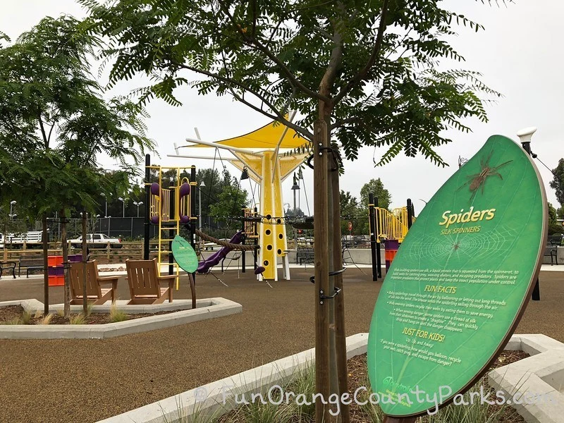 leaf shaped sign with fun facts about spiders under a tree at Cordova Park playground in Mission Viejo