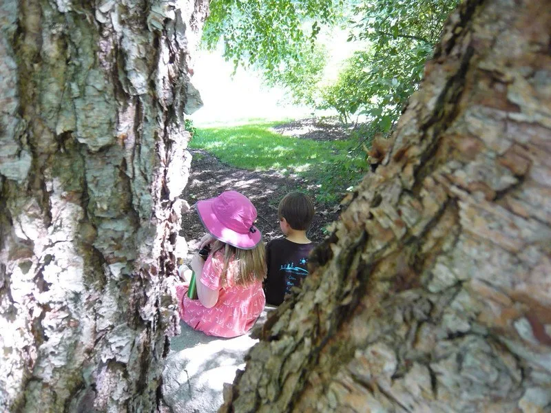 Hummingbird Parenting view of two children sitting by a tree