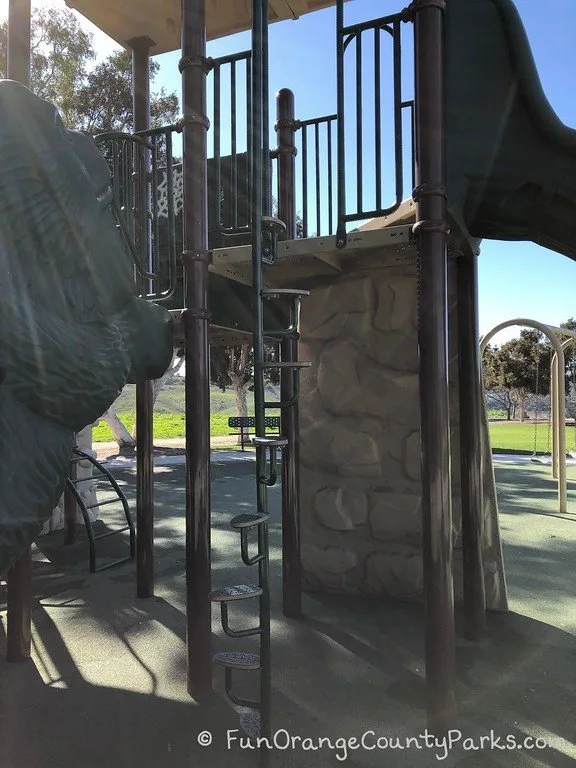 small steps on a ladder leading up to the top of the play structure