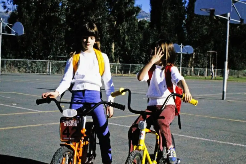 flat biking - girls on bikes at a school playground
