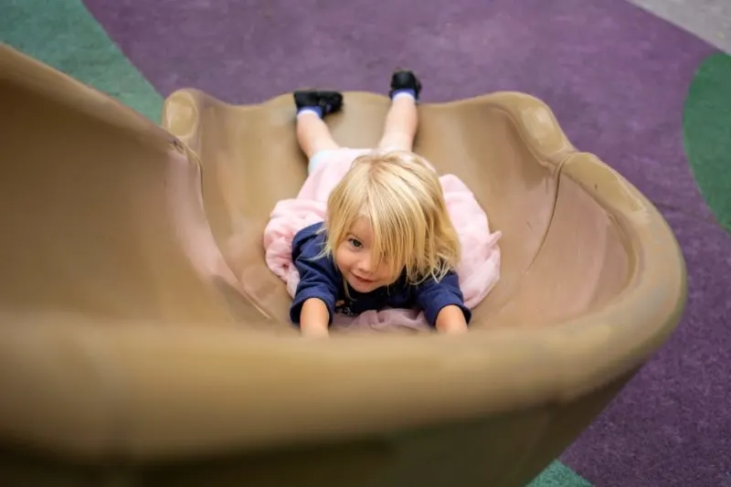 girl sliding down slide