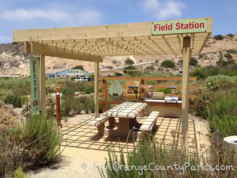 el moro canyon field station picnic area with wooden gazebo over concrete picnic table in a nature area at crystal cove state park