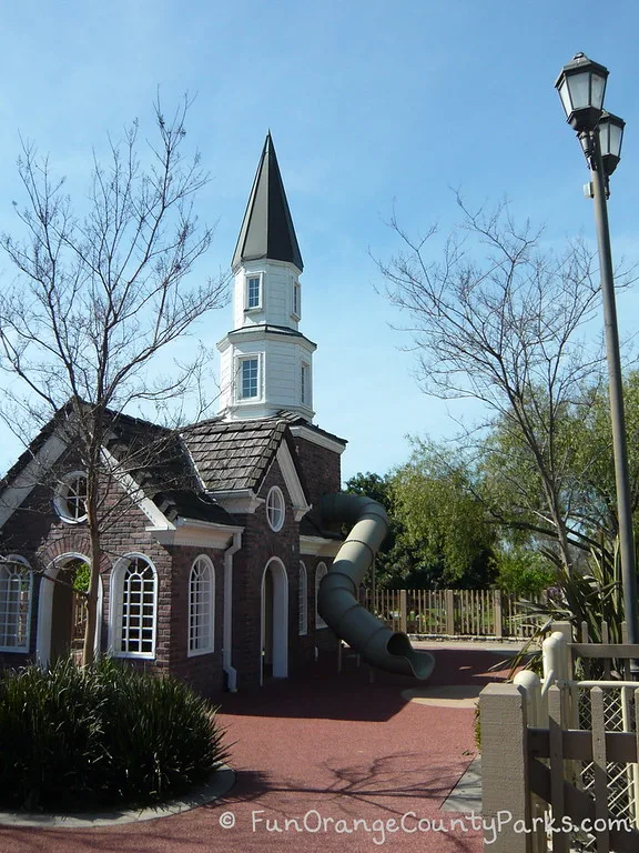 old north church building at heritage park play island in cerritos with a big tunnel slide coming down from the second story