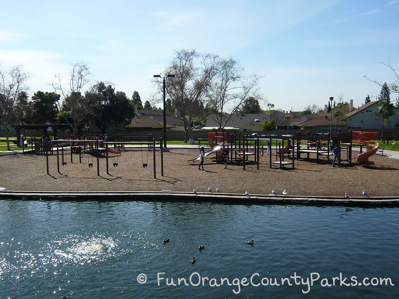 simple playground with swings and slides outside of heritage park play island in cerritos