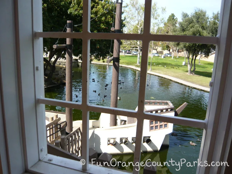 view out the playground building window onto the pirate ship