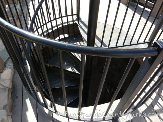 overhead view of a black iron spiral staircase where you can't see where it leads