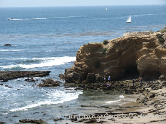 pelican point and treasure cove area of crystal cove state park with rock formation and people walking on tidepools