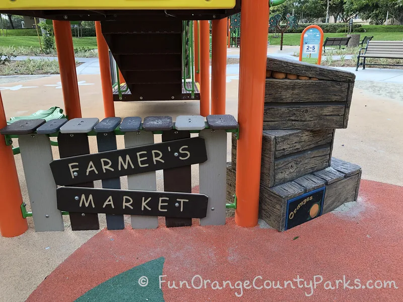 what looks like a mini Farmer's Market stand with orange crates stacked nearby which also serve as steps to access the structure