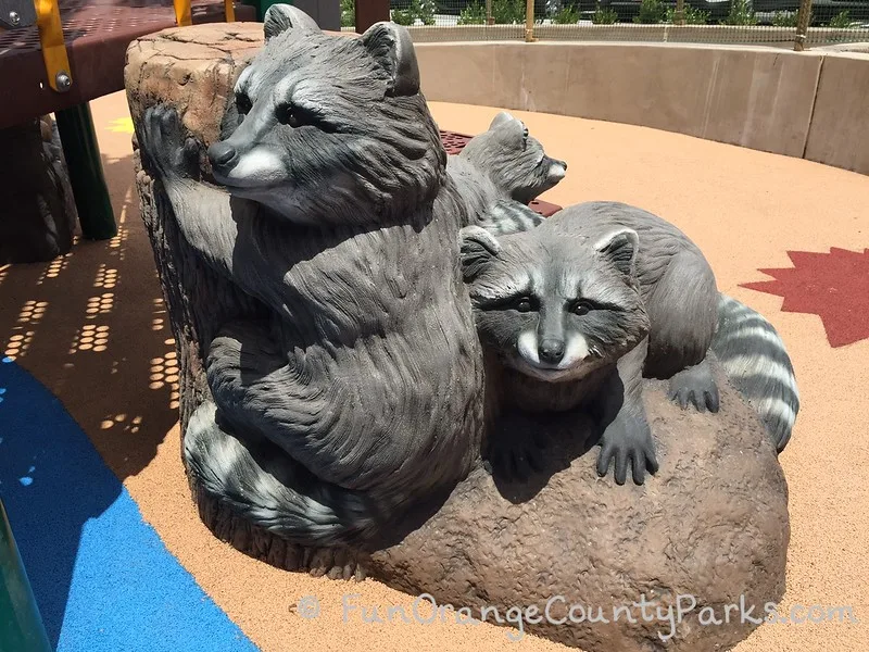 play statues of raccoons for kids to play and climb on the playground