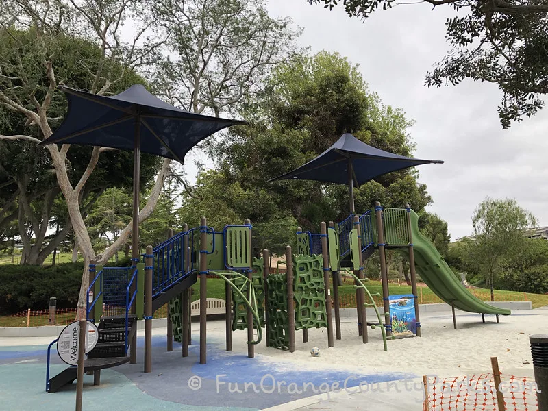 very tall play green and blue playground with slides