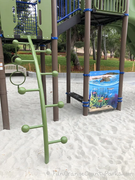 curved ladder with rungs that have baseball sized balls at the end