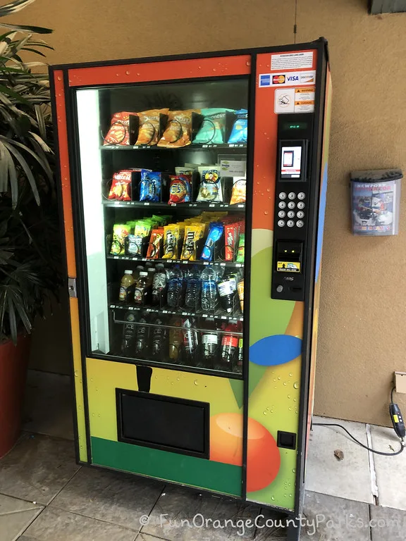 colorful vending machine stocked with snacks and water bottles