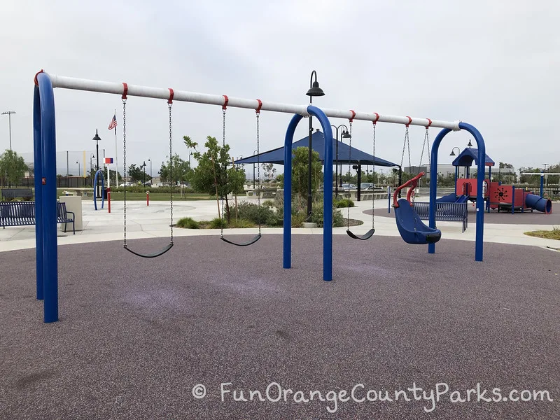 3 bench swings and one swinging chair on a playground