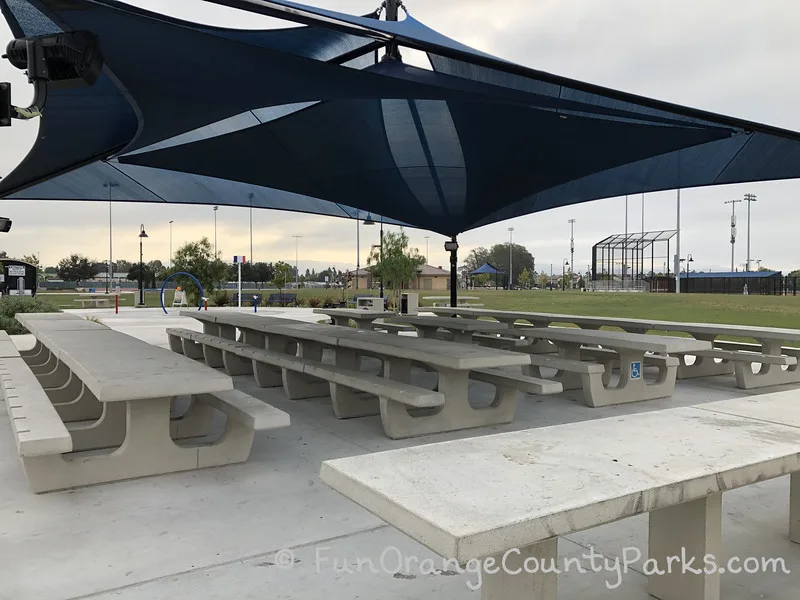 covered picnic area with splash pad just beyond