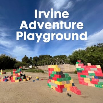 colorful stackable blocks on dirt surface at Irvine Adventure Playground with blue sky and thin white clouds on a sunny day