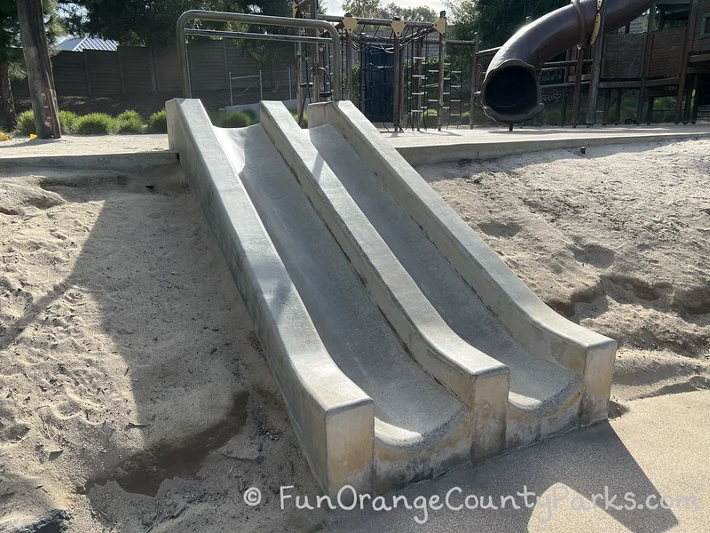 double track of short concrete slides appropriate for toddlers